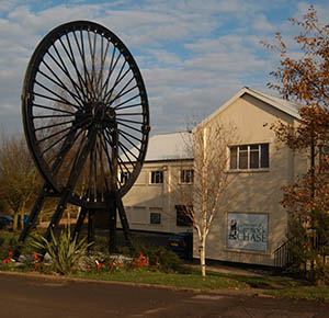 Image shows the huge pit wheel outside the Museum of Cannock Chase